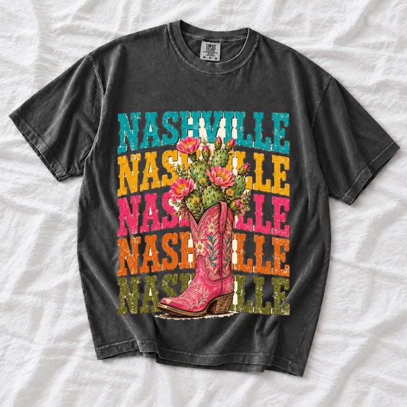Pink embroidered cowboy boot with blooming cactus over a five-line stacked NASHVILLE word in retro colors