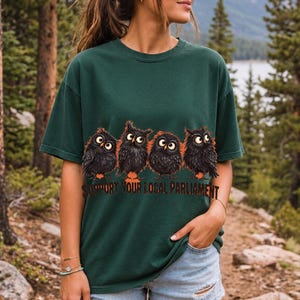 Four fluffy big-eyed black owls in a row with the text "Support Your Local Parliament"