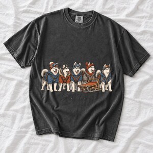 Illustrated huskies in ski gear lined up with a sled, text Sled Team