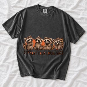 Four raccoons in a row with the text "Support Your Local Gaze"