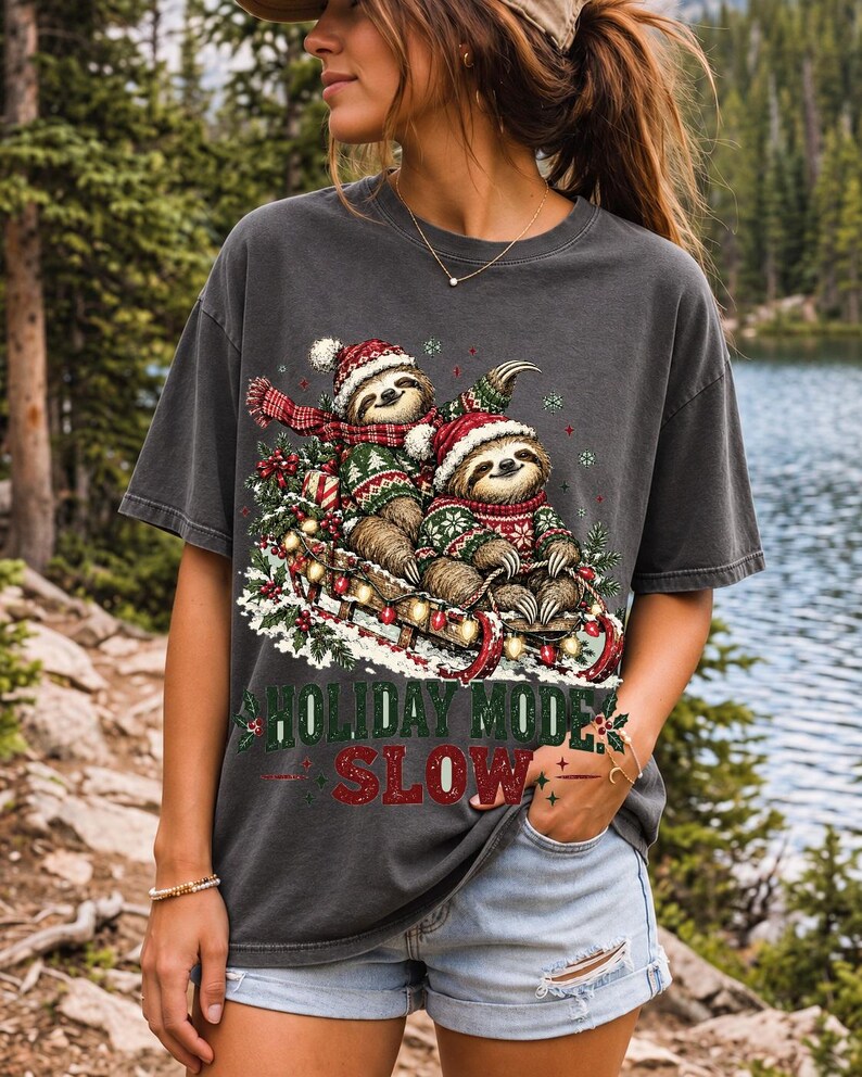 Two sloths in ugly sweaters riding a sled with lights and the text Holiday Mode: Slow