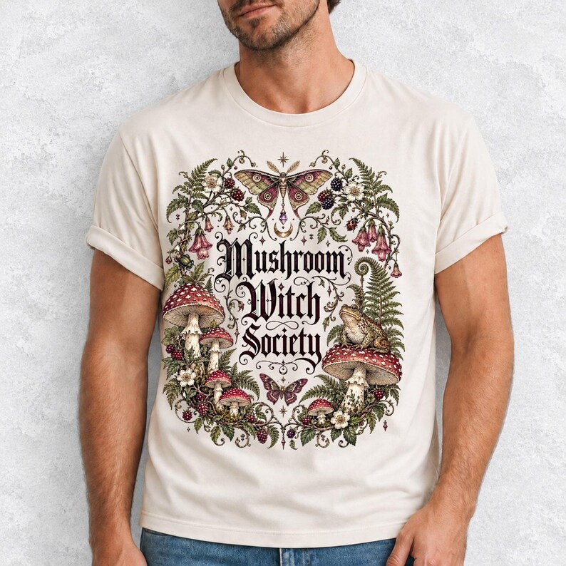 Blackletter text "Mushroom Witch Society" framed by fly agaric mushrooms, ferns and a toad on a mushroom cap