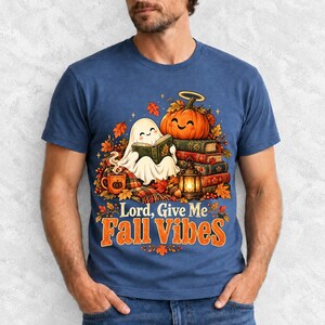 Smiling pumpkin with a halo beside a stack of books and a lantern, text "Lord, Give Me Fall Vibes", retro fall illustration