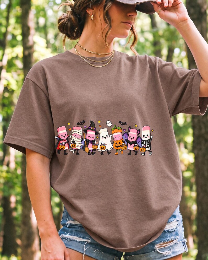 Seven cute erasers with faces in Halloween costumes holding candy buckets, flat crayon colors