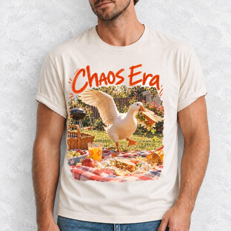 Goose stealing a sandwich from a picnic blanket, 90s film photo style, text "Chaos Era"