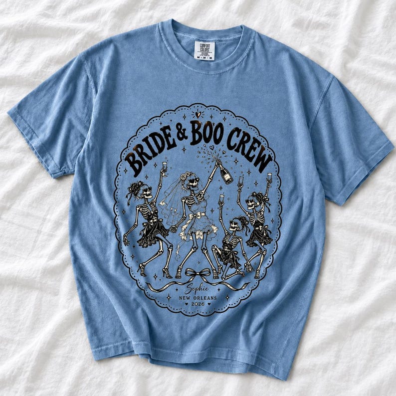 Skeleton bride popping champagne with cheering skeleton bridesmaids and the text Bride & Boo Crew