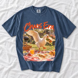 Goose stealing a sandwich from a picnic blanket, 90s film photo style, text "Chaos Era"