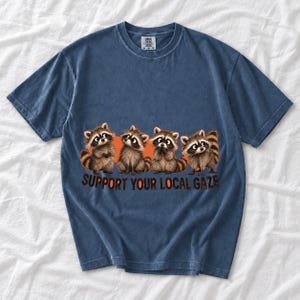 Four raccoons in a row with the text "Support Your Local Gaze"