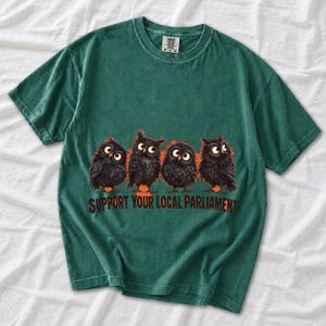 Four fluffy big-eyed black owls in a row with the text "Support Your Local Parliament"