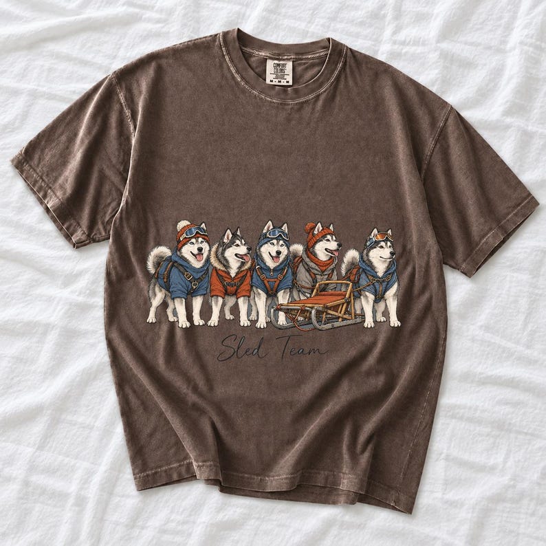 Illustrated huskies in ski gear lined up with a sled, text Sled Team