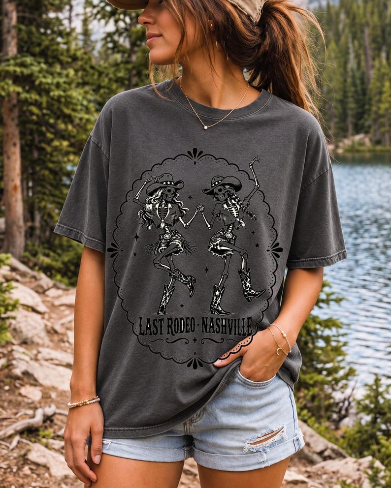 Two cowgirl skeletons in hats line dancing in a starry frame with the text Last Rodeo Nashville