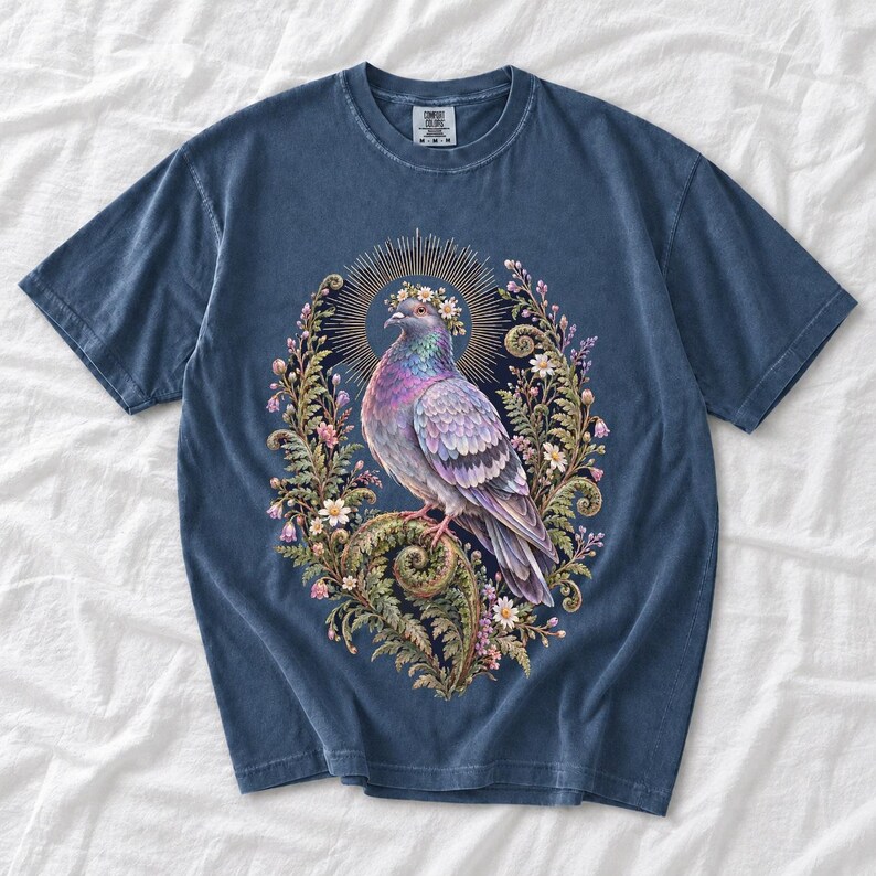 Painted pigeon wearing a daisy crown and glowing halo standing on a fern frond, whimsical cottagecore bird t-shirt art