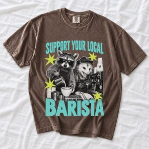 Raccoon and opossum behind an espresso machine, zine collage, text "Support Your Local Barista"