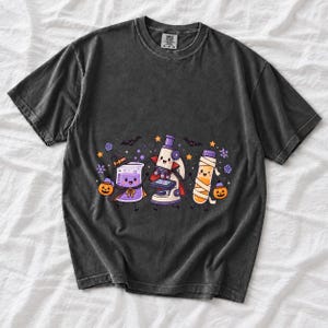 Kawaii beaker, microscope and test tube with faces in Halloween costumes, pastel purple and orange