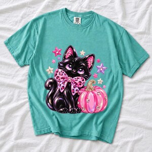 Puffy 3D black cat with a leopard bow beside a glossy pumpkin and stars in coquette style