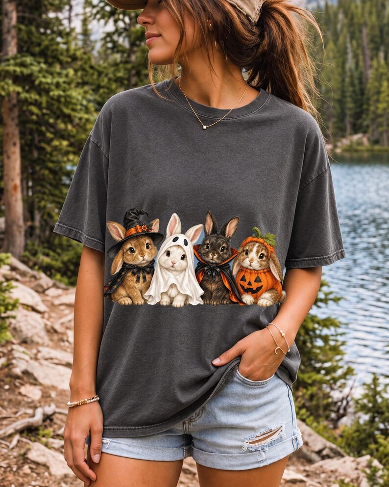 Realistic illustration of four bunnies in witch, ghost, vampire cape and pumpkin costumes in a row