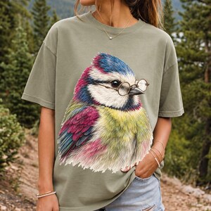 Colored-pencil blue tit bird wearing tiny round reading glasses, funny birdwatcher t-shirt illustration