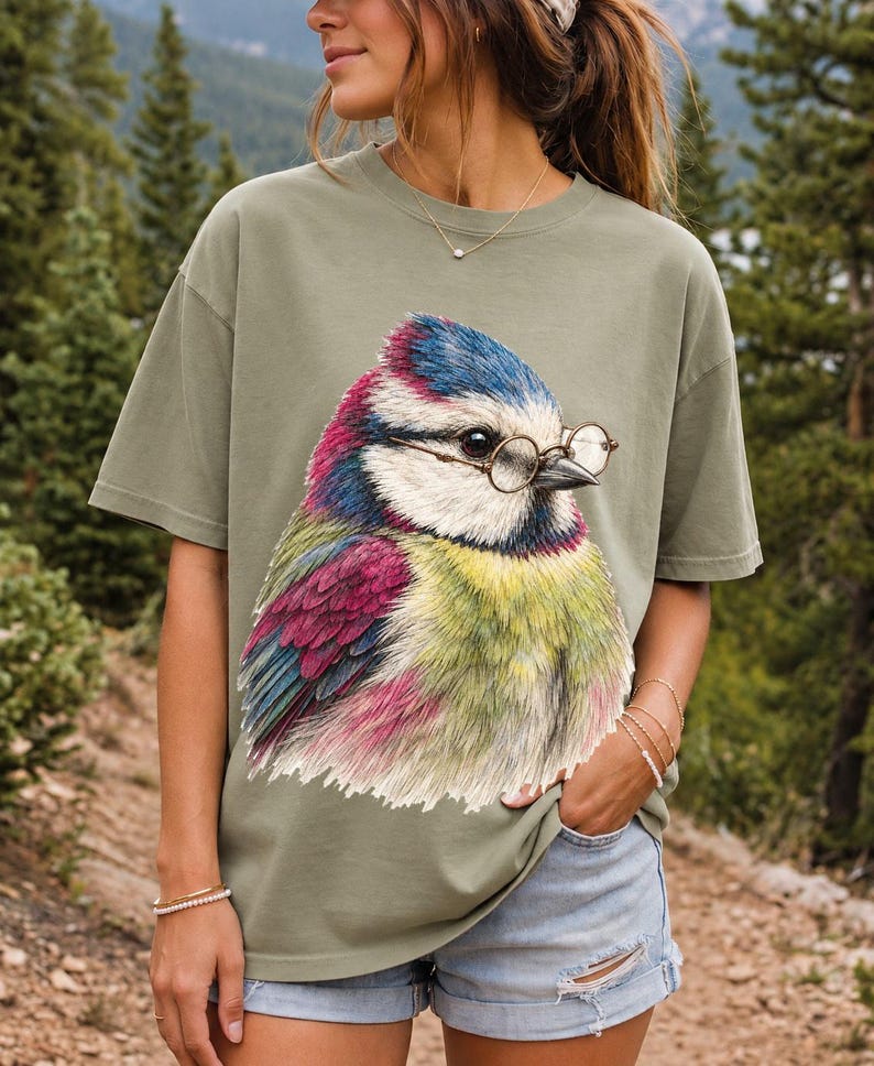 Colored-pencil blue tit bird wearing tiny round reading glasses, funny birdwatcher t-shirt illustration
