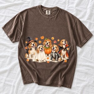 Five watercolor beagles in witch, ghost, pumpkin, skeleton and vampire costumes with floating autumn leaves