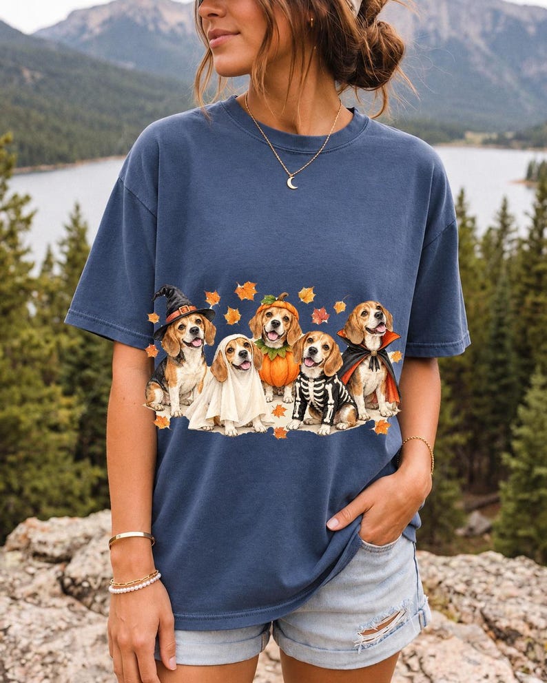 Five watercolor beagles in witch, ghost, pumpkin, skeleton and vampire costumes with floating autumn leaves