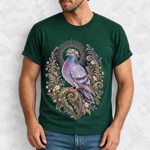 Painted pigeon wearing a daisy crown and glowing halo standing on a fern frond, whimsical cottagecore bird t-shirt art