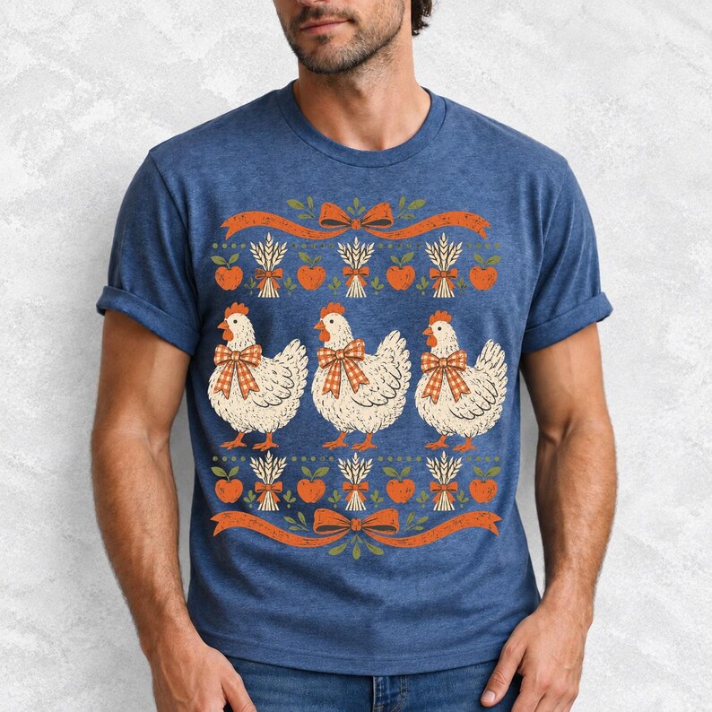 Three fluffy hens with gingham bows between apple and wheat borders, retro folk art fall t-shirt design