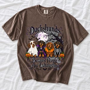 Four dachshunds in Halloween costumes under a spooky tree with text Dachshunds, Because People Are Exhausting