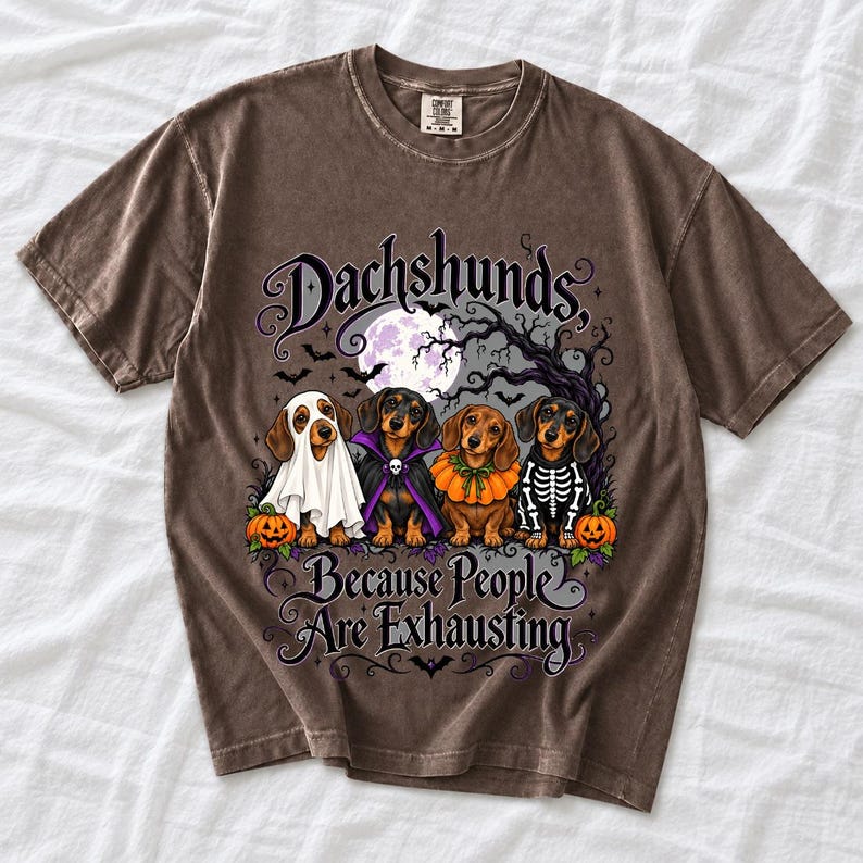 Four dachshunds in Halloween costumes under a spooky tree with text Dachshunds, Because People Are Exhausting
