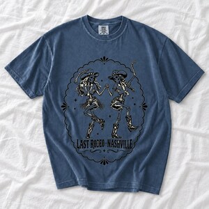 Two cowgirl skeletons in hats line dancing in a starry frame with the text Last Rodeo Nashville