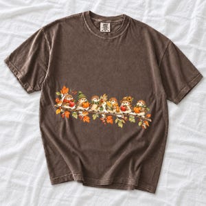 Row of watercolor sparrows on a branch holding tiny apples, corn and a pumpkin for harvest