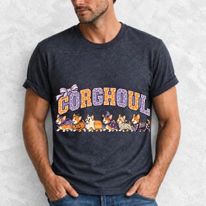 Six corgis in Halloween costumes walking under the arched word CORGHOUL, lavender and orange polka-dot varsity style