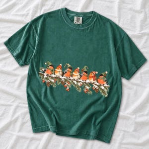 Watercolor bullfinches and robins in elf hats and scarves on a snowy pine branch
