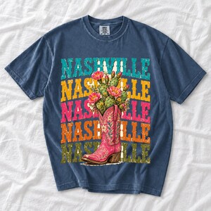 Pink embroidered cowboy boot with blooming cactus over a five-line stacked NASHVILLE word in retro colors