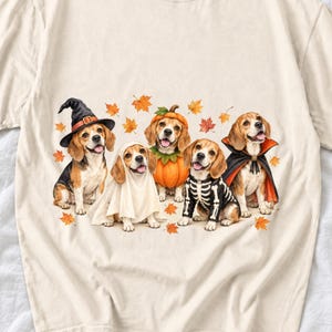 Five watercolor beagles in witch, ghost, pumpkin, skeleton and vampire costumes with floating autumn leaves