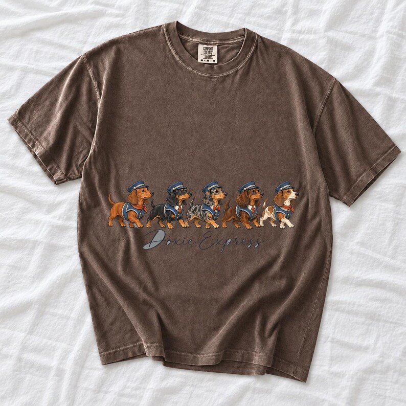 Illustrated dachshunds in conductor hats lined up like a train, text Doxie Express