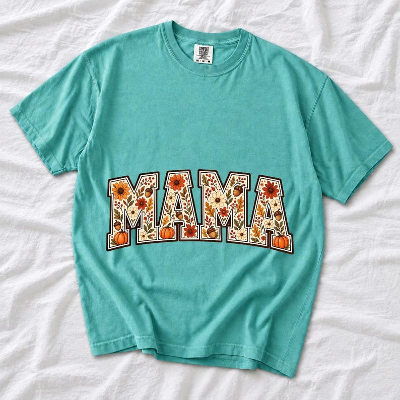 Arched varsity word MAMA filled with fall flowers and acorns in cream, rust and mustard