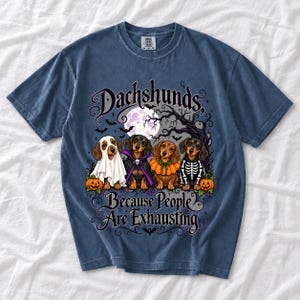 Four dachshunds in Halloween costumes under a spooky tree with text Dachshunds, Because People Are Exhausting