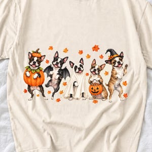 Five watercolor Boston terriers in Halloween costumes with falling autumn leaves