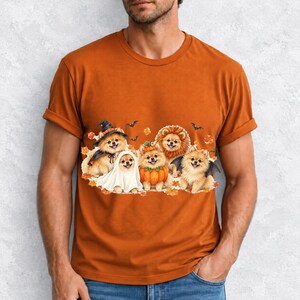 Five fluffy watercolor pomeranians in Halloween costumes with autumn leaves and bats