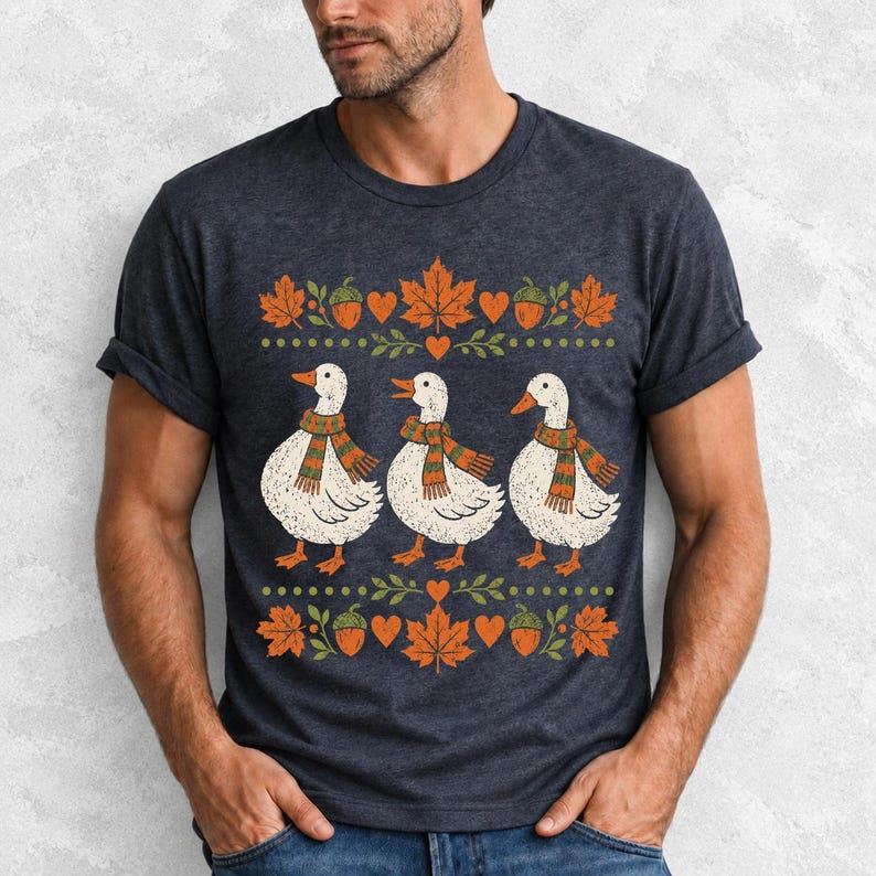 Three white ducks in striped scarves with acorn and maple leaf borders, retro screen print fall t-shirt art