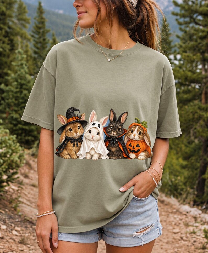 Realistic illustration of four bunnies in witch, ghost, vampire cape and pumpkin costumes in a row