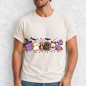 Kawaii books, pencil and bookmark with faces in Halloween costumes, pastel purple and orange