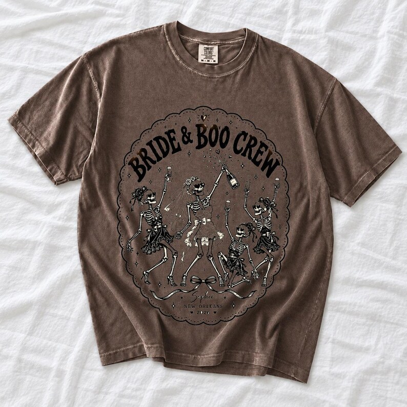 Skeleton bride popping champagne with cheering skeleton bridesmaids and the text Bride & Boo Crew