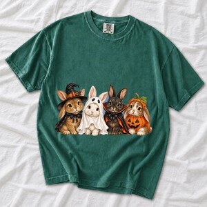 Realistic illustration of four bunnies in witch, ghost, vampire cape and pumpkin costumes in a row