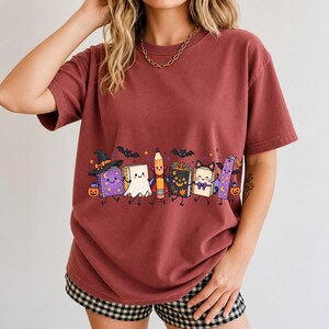 Kawaii books, pencil and bookmark with faces in Halloween costumes, pastel purple and orange