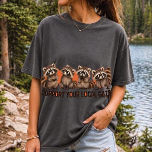 Four raccoons in a row with the text "Support Your Local Gaze"