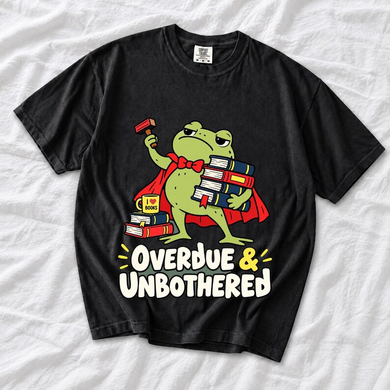 Grumpy cartoon frog librarian holding a stamp and a stack of books with the text Overdue & Unbothered