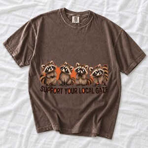 Four raccoons in a row with the text "Support Your Local Gaze"