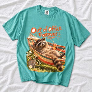Raccoon relaxing in a hammock with a soda can and sunglasses, 90s film photo style, text "Out of Office Forever"