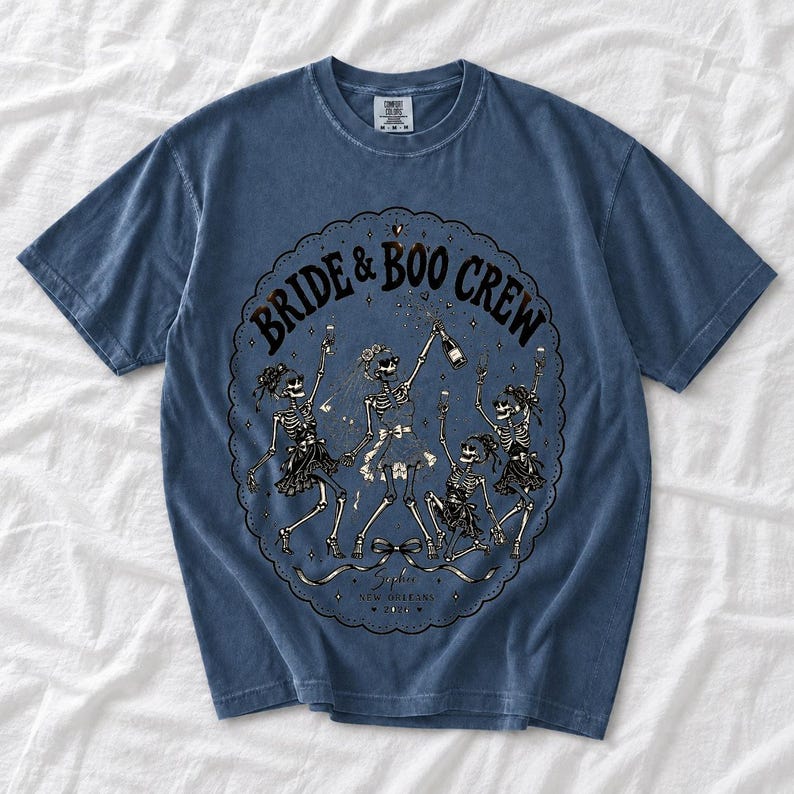 Skeleton bride popping champagne with cheering skeleton bridesmaids and the text Bride & Boo Crew